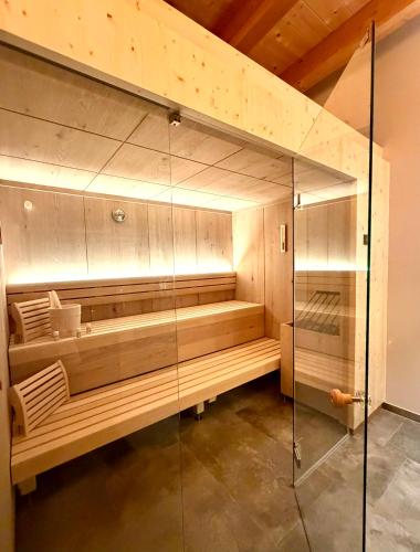 a sauna with a glass shower in a room at MALIA - Alpine Hideaway in Pertisau