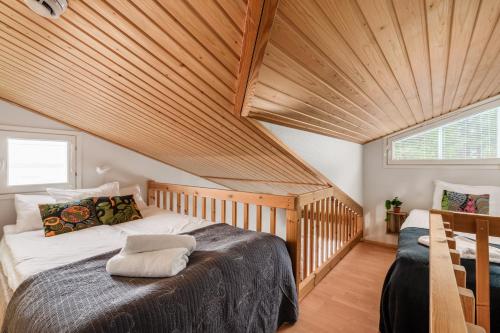 a bed in a room with a wooden ceiling at Levi Lumia Home, Moonlight 409 in Levi