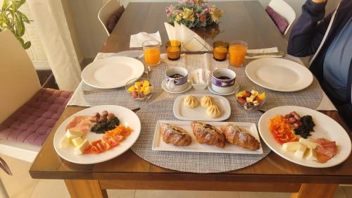 a table with plates of food on top of it at Ta’ Giljan B&B Gozo in Xagħra