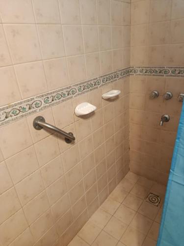 a bathroom with a shower with two toiletries at Das Kleine Nest in Villa General Belgrano