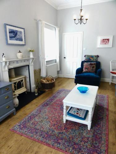 a living room with a couch and a coffee table at Holmlea Cottage in Freuchie