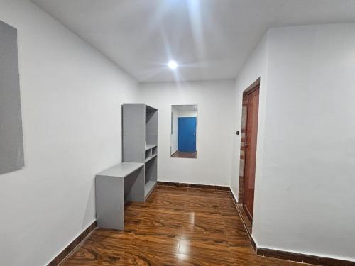 an empty room with white walls and wooden floors at Mystic Resort Dublagadi in Balasore