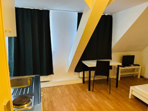 una habitación con una mesa y una cortina negra en Hotel Westend, en Colonia