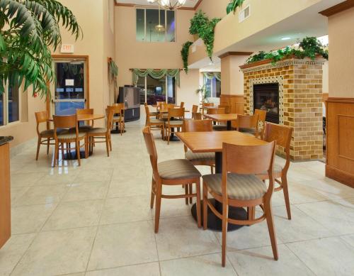 a restaurant with tables and chairs and a fireplace at Holiday Inn Express Hotel & Suites Carson City by IHG in Carson City