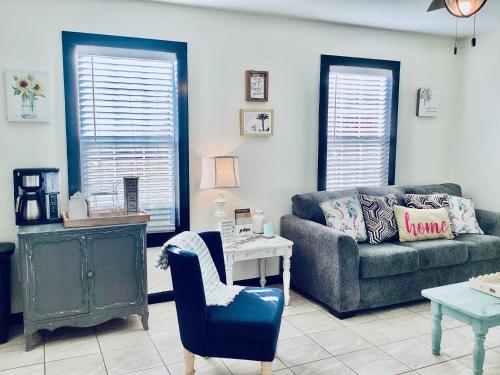 a living room with a couch and a chair at Urban Aquarium Home for 8 in Galveston