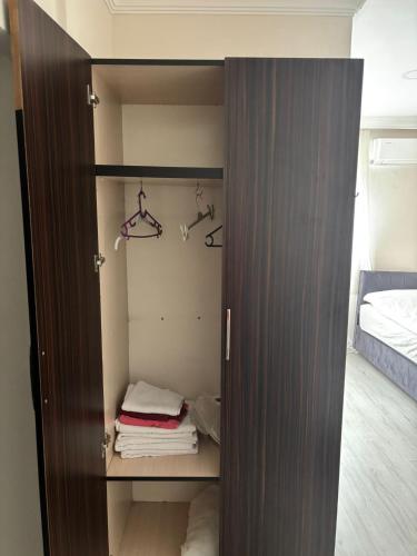 a closet with towels and hangers in a bedroom at Hevsel hotel in Diyarbakır