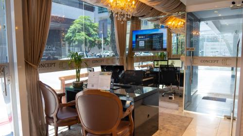 a lobby of a office with chairs and a desk at Concept Hotel Flat in Balneário Camboriú