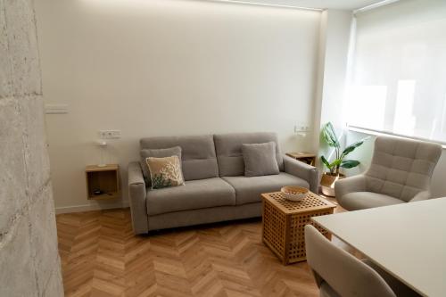 a living room with a couch and two chairs at Luxury Gran Vía centro Murcia in Murcia