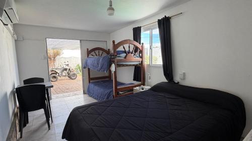 a bedroom with a bed and a room with a window at brisas del dique in San Fernando del Valle de Catamarca