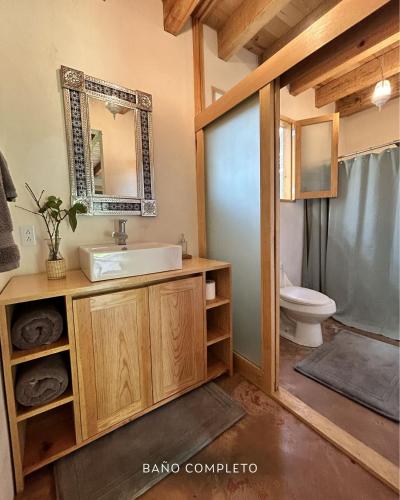 a bathroom with a sink and a toilet at Rancho el Capricho in Valle de Bravo