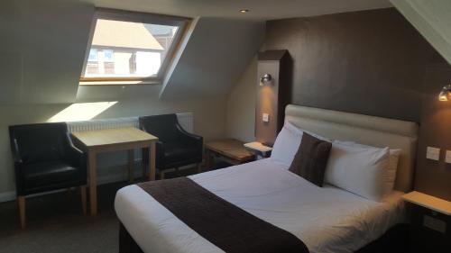 Postel nebo postele na pokoji v ubytování Beaumond Cross Inn