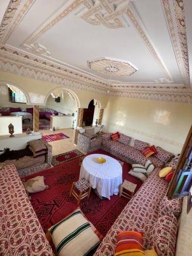 a living room with a table and a couch at Villa ayyur in Souira Guedima