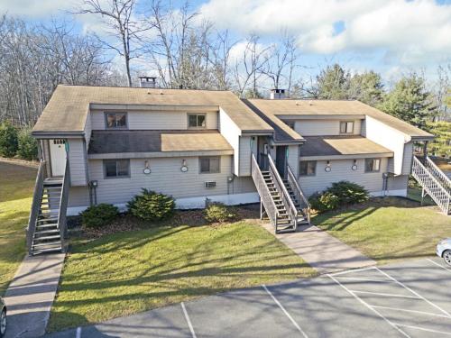 a house with a garage and a driveway at Westwood Villas by Coolvacay in Lake Harmony