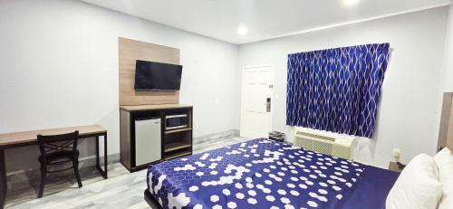 a bedroom with a bed and a desk and a desk at Airway Inn - IAH Airport in Houston
