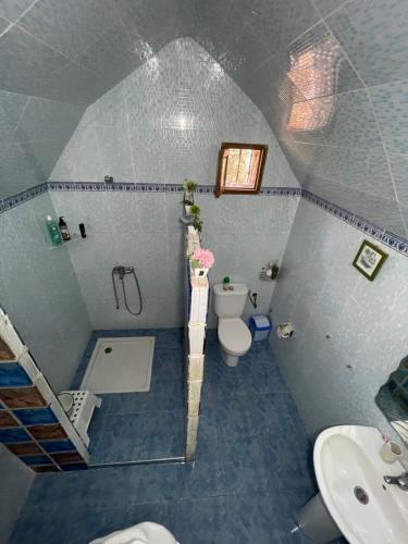 a small bathroom with a toilet and a sink at Villa ayyur in Souira Guedima