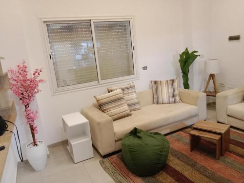a living room with a couch and a table at Front beach cosy apartment in La Goulette