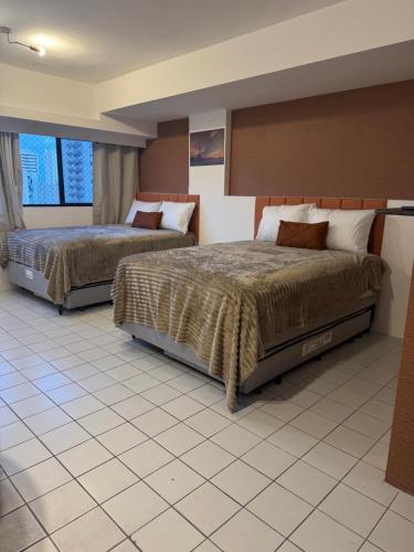 Ένα ή περισσότερα κρεβάτια σε δωμάτιο στο Seu cantinho no Centro do Recife