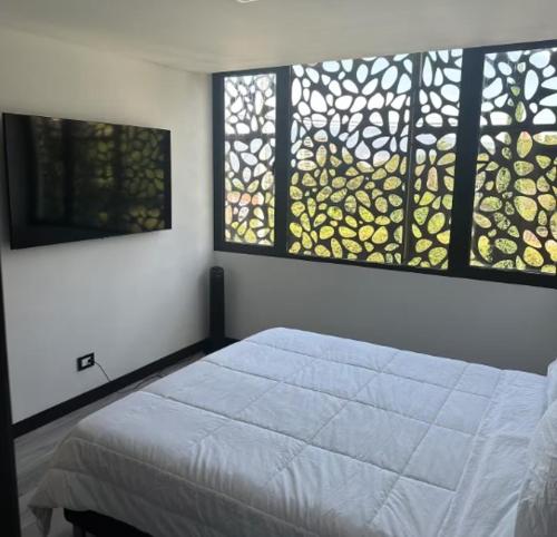 Ένα ή περισσότερα κρεβάτια σε δωμάτιο στο 101 Poblado apartamento