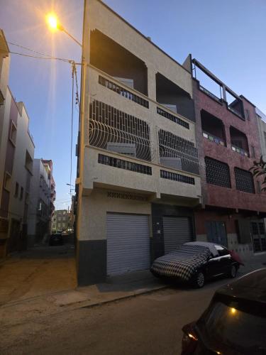 a building with a car parked in front of it at Appartement 3S in Meknès