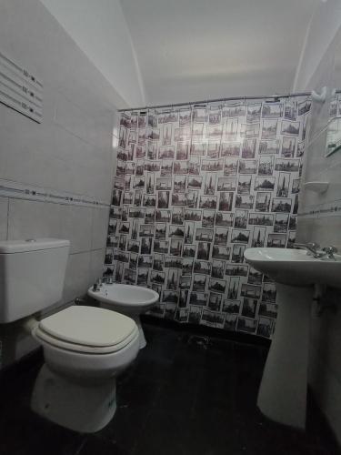 a bathroom with a toilet and a sink at Casa Serrana Punilla in Santa María