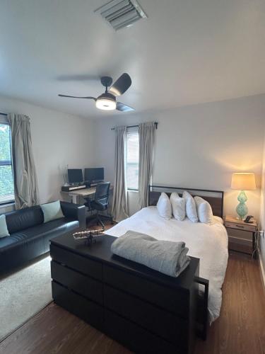 a bedroom with a bed and a couch and a desk at Cozy Home away from home! in Miami