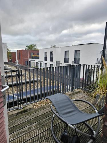 a chair sitting on a balcony next to a fence at Kopje van Haaglanden in The Hague