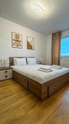 a bedroom with a large bed and a window at VENUS Studios at Coresi Mall in Braşov