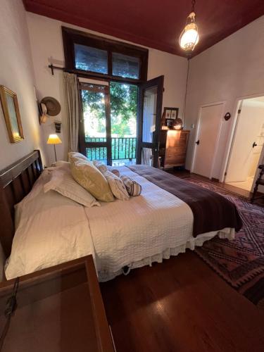 a bedroom with a large bed with a window at Lodge Boutique Casa Cardonal in Paine