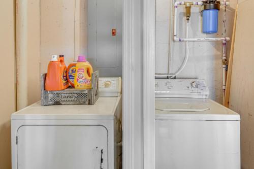 a laundry room with orange detergent and a washing machine at Private Lakefront Home with Views and Dock in Hartwell in Reed Creek