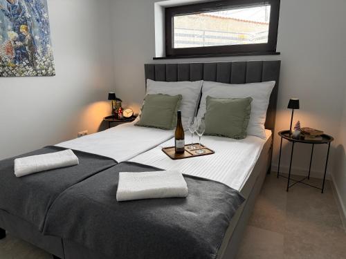 a bedroom with a large bed with a bottle of wine on it at Apartament u Bacy in Nowy Targ