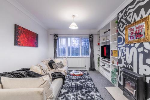 a living room with a couch and a tv at Stylish Two-Bed Apartment in Ashford in Ashford