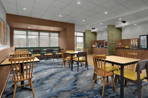 a dining room with tables and chairs and windows at Fairfield Inn & Suites by Marriott Jeffersonville I-71 in Jeffersonville