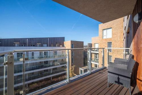 a balcony with a bench on top of a building at Stunning 2BR flat with balcony in Maidenhead