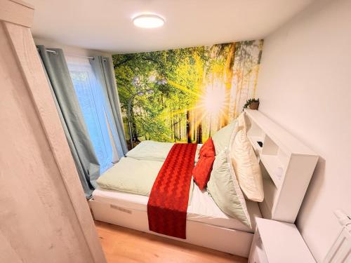 a small bed in a room with a window at Chalet im Wald mit Sauna in Schönwalde