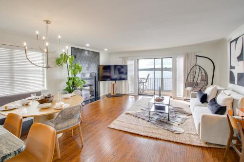 a living room with a white couch and a table at Sunset-View Resort Condo on Lake Hamilton! in Hot Springs