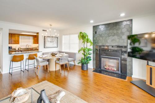 a living room with a table and a fireplace at Sunset-View Resort Condo on Lake Hamilton! in Hot Springs