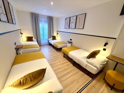 a hotel room with three beds in a room at Mucho Madrid in Madrid
