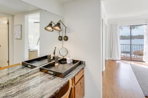 a kitchen with a sink and a view of the water at Sunset-View Resort Condo on Lake Hamilton! in Hot Springs