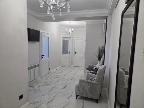 a hallway with two chairs and a chandelier at Уютный Дом in Chişinău