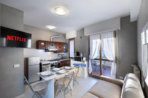 a kitchen and living room with a table and chairs at Sweetie Tuscany House in Montecatini Terme