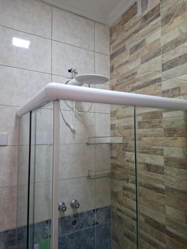 a bathroom with a shower with a glass at Hosting Altos da cidade perto de tudo in Bauru