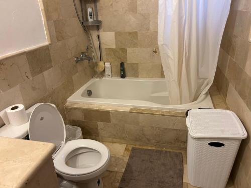 een badkamer met een toilet en een bad met een wastafel bij Cozy apartment in Punta Cana