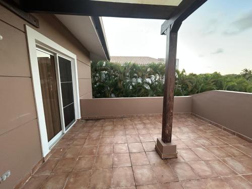 een kamer met een balkon en een groot raam bij Cozy apartment in Punta Cana