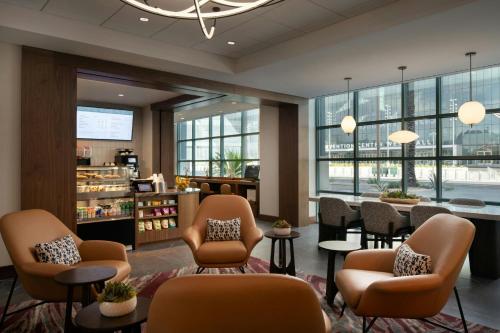 a waiting room with chairs and tables and windows at Las Vegas Marriott in Las Vegas