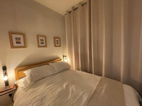 a bedroom with a white bed and a window at Cosy Coastal getaway 2 bed flat in Largs in Largs