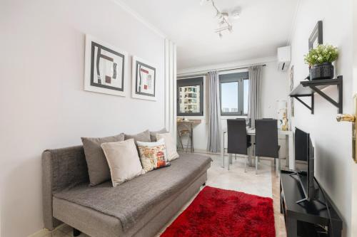 a living room with a couch and a red rug at Lisbon Relax Pool Apartment - Free Parking Garage in Lisbon