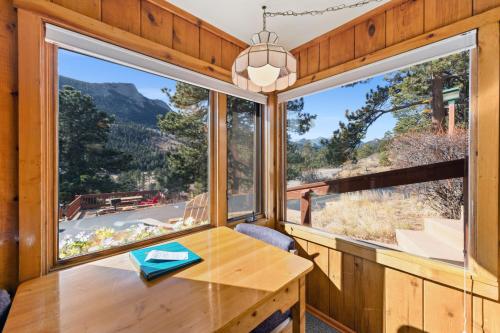 a dining room with a table and a large window at McGregor Mountain Lodge in Estes Park