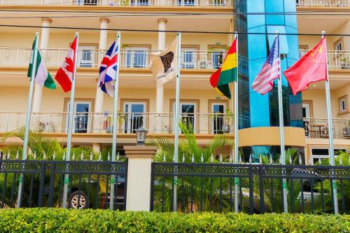 a group of flags in front of a building at Sasselo Hotel in Accra