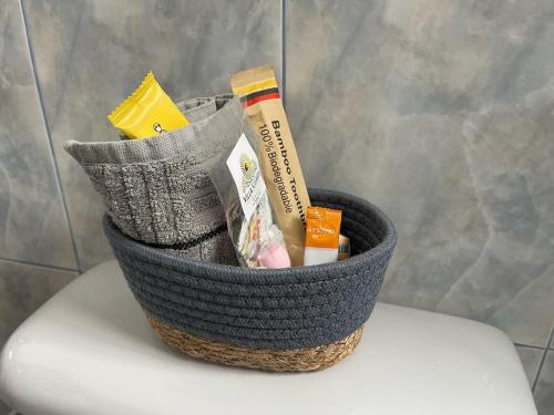 a basket sitting on top of a toilet seat at Villa Solara - A Beachfront Residence in San Clemente