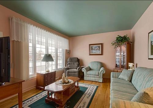 a living room with a couch and a table at 2beds in Room A Free parking 15min to downtown in Longueuil